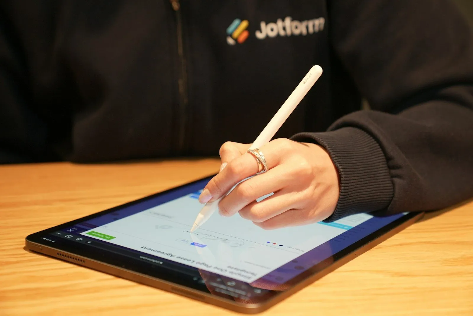 Person writing on a tablet with a pen