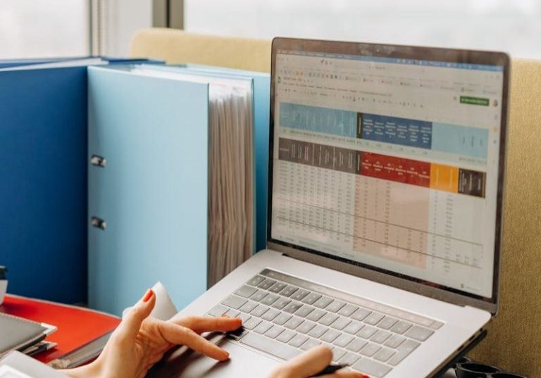 Business workspace with folders and laptop showing analytics screen. Ideal for tech and work themes.