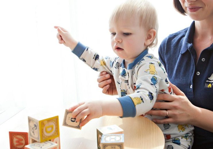 toddler playing learning blocks